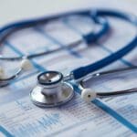 A stethoscope on top of a patient's chart