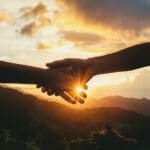 Hands shaking with landscape in background