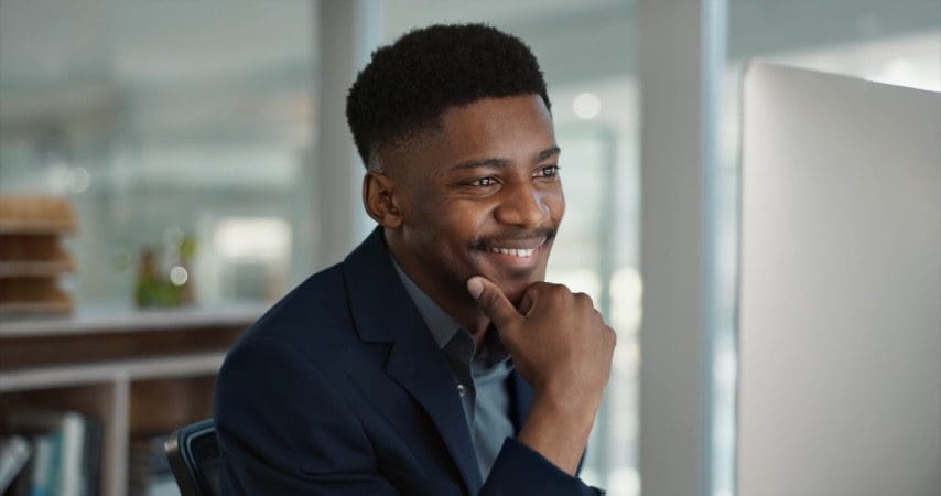 Man looking at a computer smiling